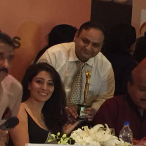 Award presentation with trophy and guests